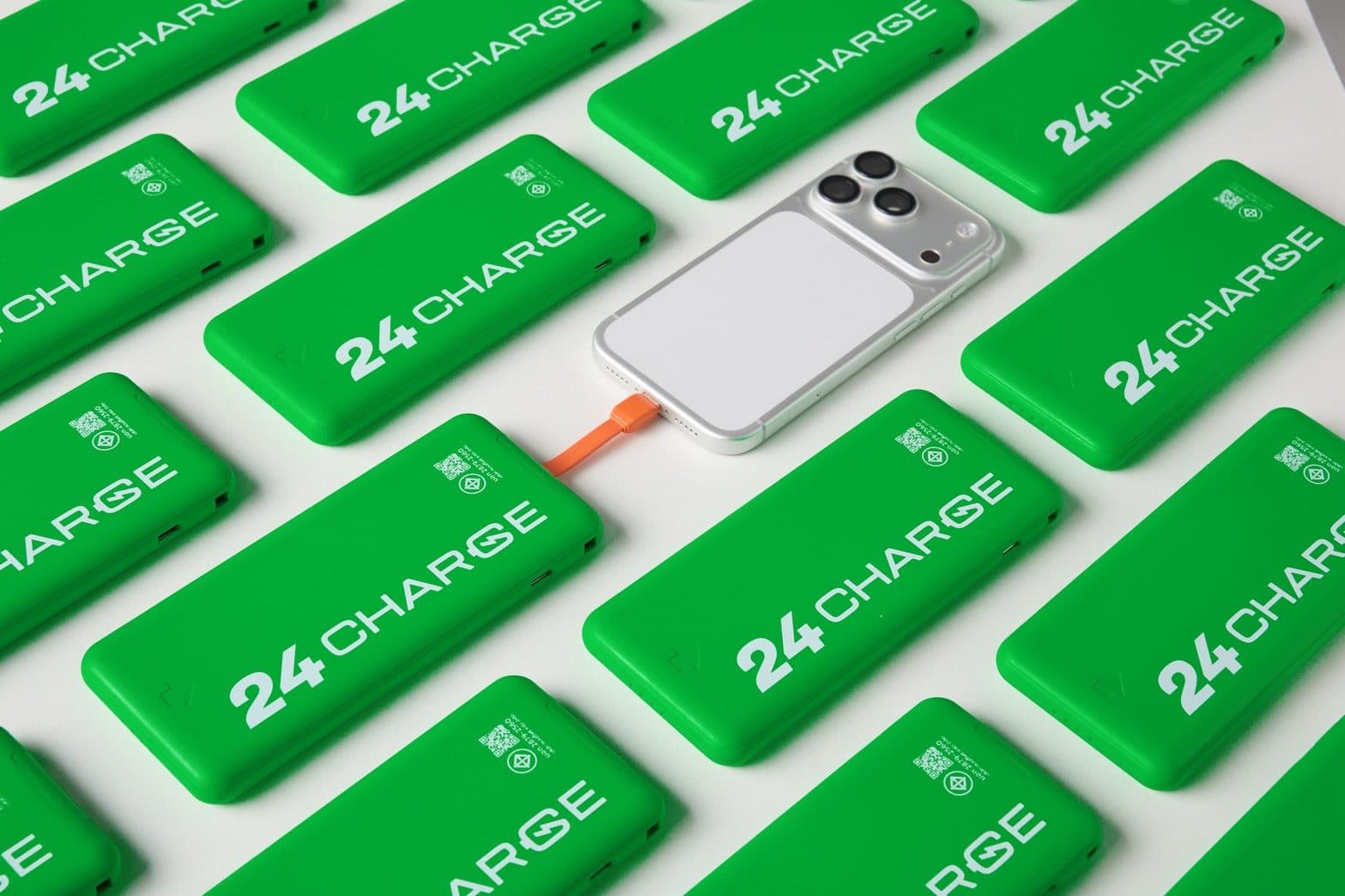 24CHARGE power banks tiled across the frame with one phone plugged into an orange cable in the middle